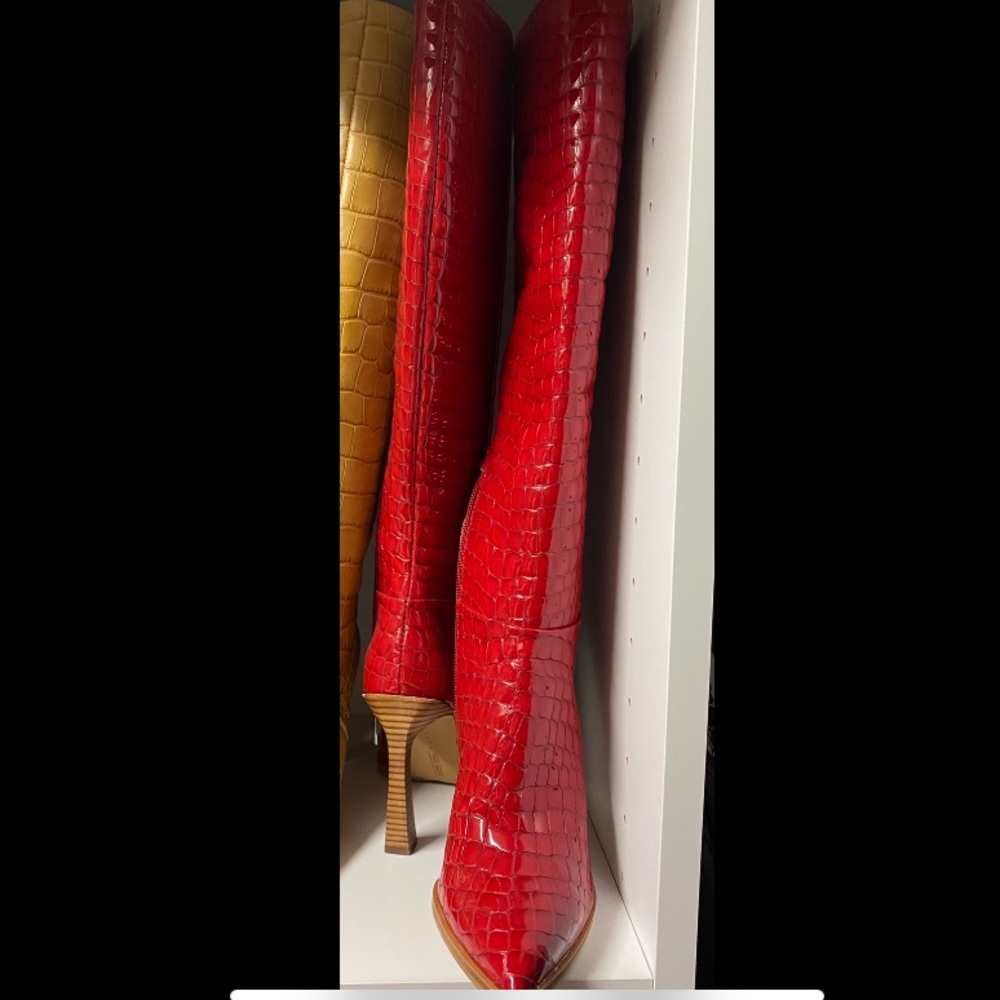Knee high red boots.